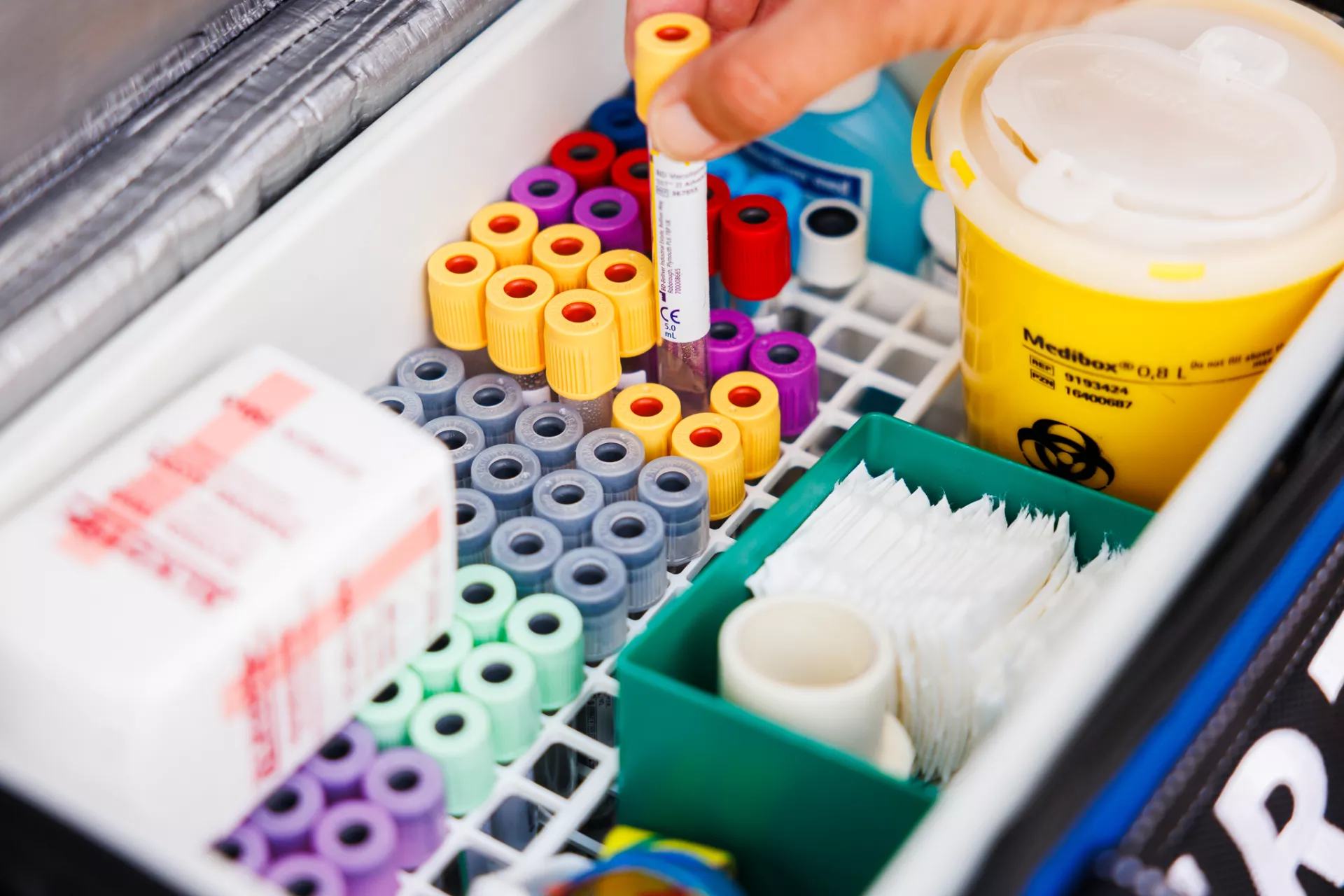 Lege bloedbuisjes in een tas met hand 