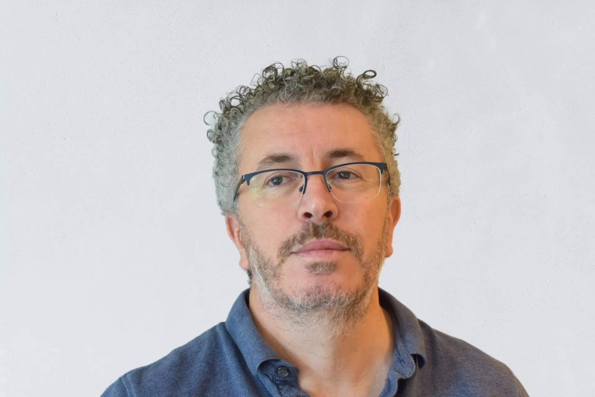 Portret Aziz al Moujahid voor grijze wand